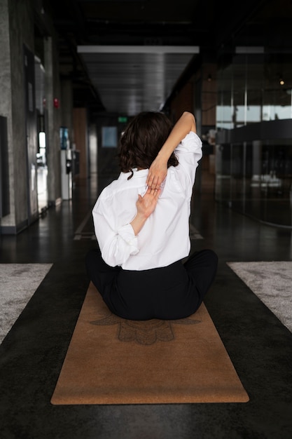 Photo gratuite plein coup femme qui s'étend au travail