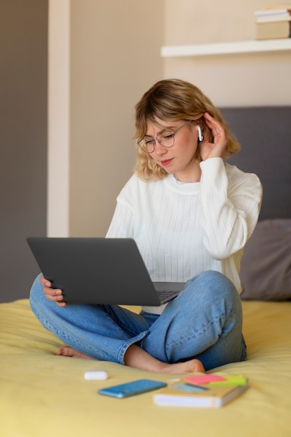 Plein coup femme travaillant dans son lit