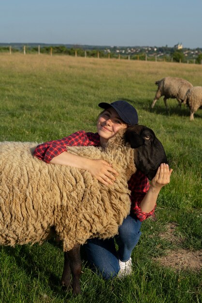 Plein coup smiley femme étreignant des moutons