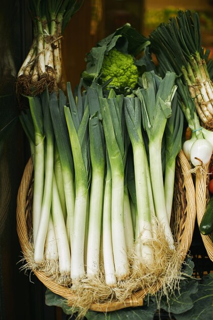 Poireau frais dans le panier présenté à l'extérieur sur le marché pour la vente