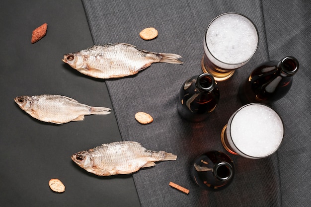 Photo gratuite poisson plat à poser avec des verres à bière et des bouteilles