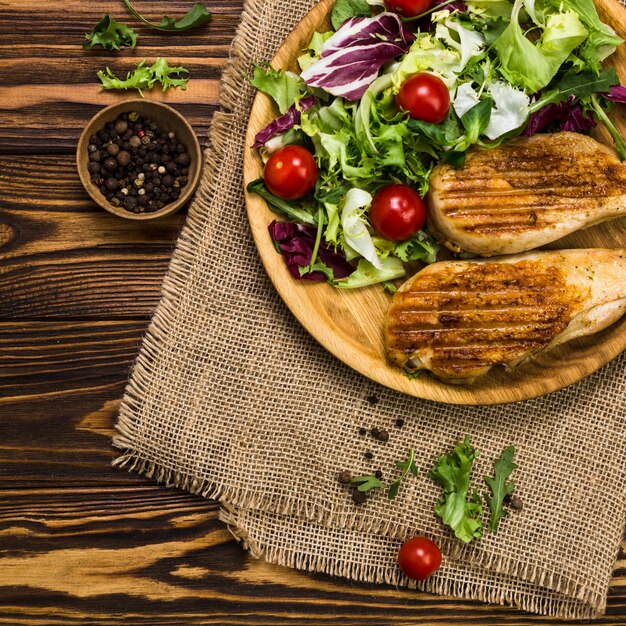 Poivre noir près de la salade et du poulet rôti