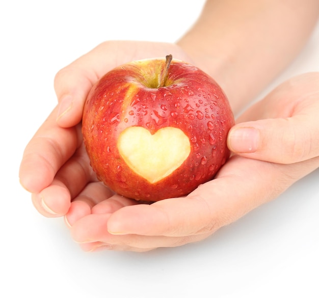 Pomme rouge avec coeur en mains isolé sur blanc