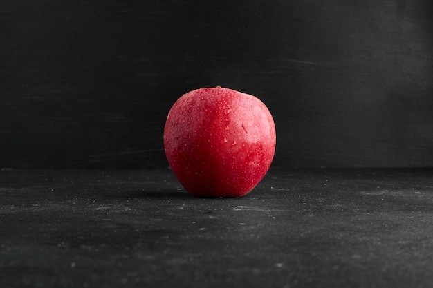 Une Pomme Rouge Isolée Sur Une Surface Noire.