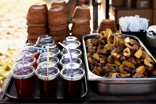 Photo gratuite pommes de terre au four et tasses avec du jus