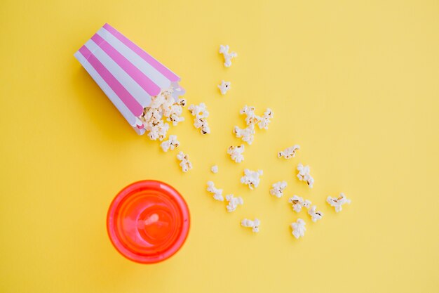 Pop-corn renversé près de la tasse de boisson