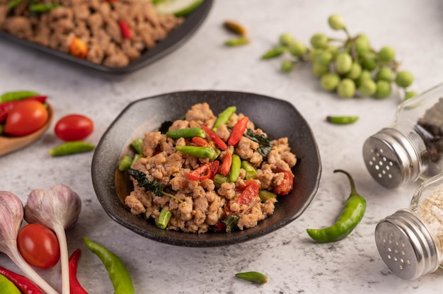 Porc haché épicé et riz sur une plaque noire.