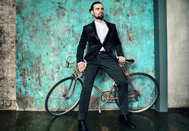 portrait de beau modèle élégant homme d'affaires hipster vêtu d'un élégant costume noir.