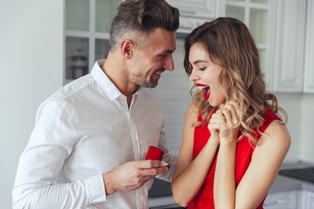 Portrait d'un bel homme proposant à sa petite amie heureuse