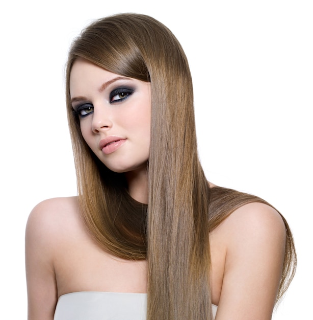 Portrait de la belle adolescente aux longs cheveux raides et maquillage des yeux noirs - fond blanc