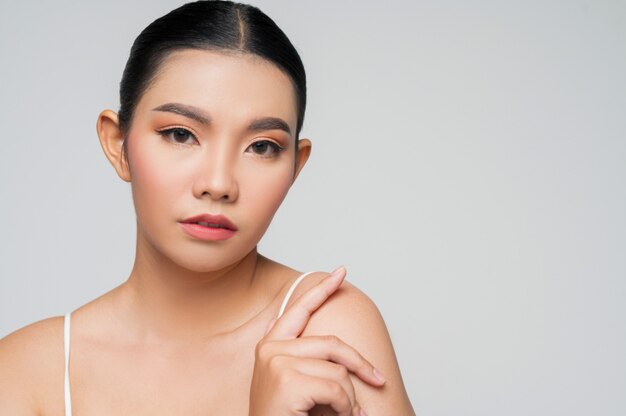 Portrait d'une belle femme asiatique aux cheveux noirs et aux lèvres roses