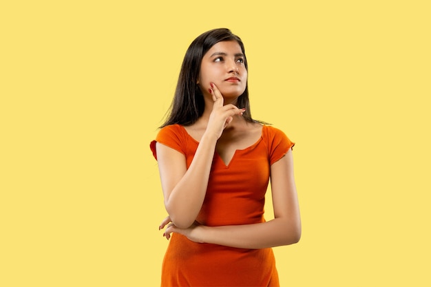 Portrait de belle femme isolée sur fond de studio jaune