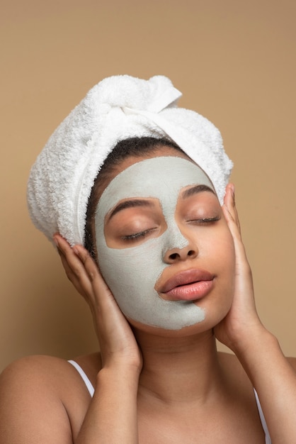 Photo gratuite portrait d'une belle femme portant un masque facial et posant