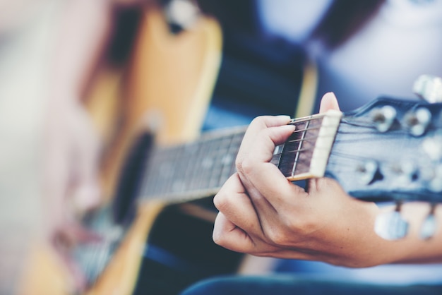 Portrait de belle fille jouant de la guitare avec vélo à la nature