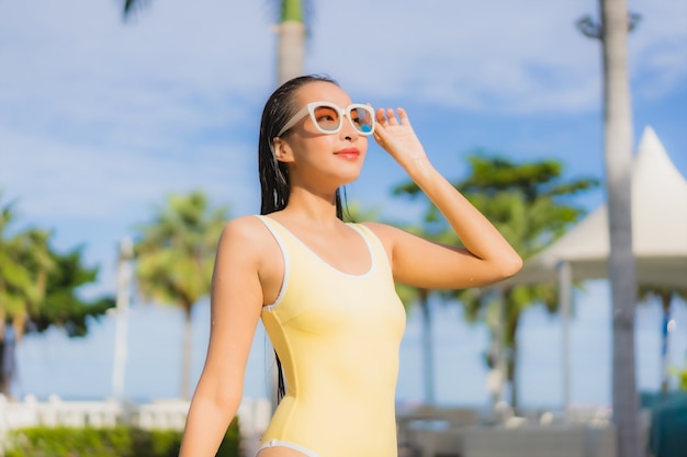 Portrait belle jeune femme asiatique de détente en plein air dans la piscine en voyage de vacances