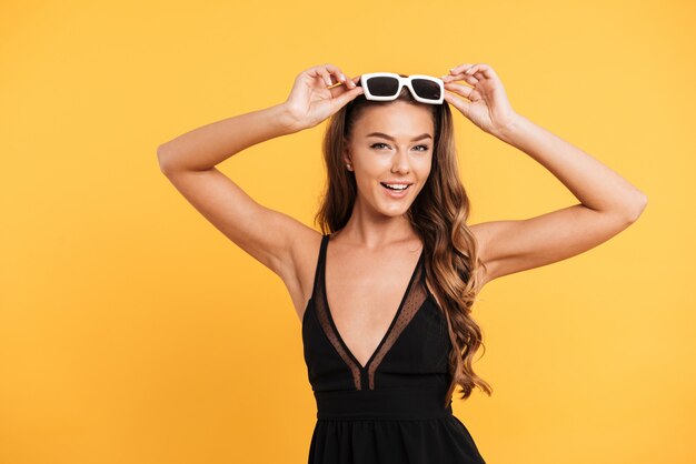 Portrait d'une belle jeune fille souriante en robe noire