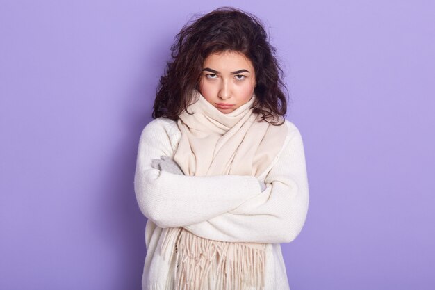 Portrait de brune douce déprimée bouleversée ayant les bras croisés