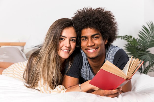 Portrait de couple interracial lisant ensemble