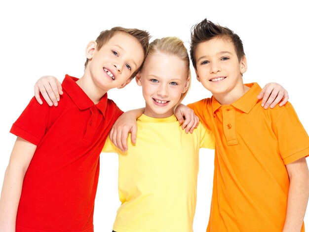 Portrait des enfants heureux isolés sur blanc. Amis écoliers debout ensemble et