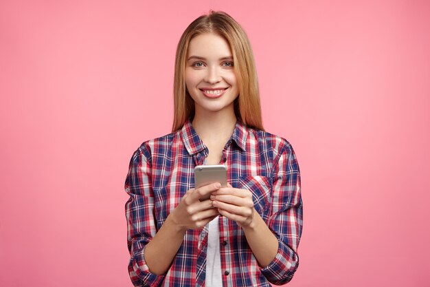 Portrait de femme blonde en chemise rayée avec téléphone