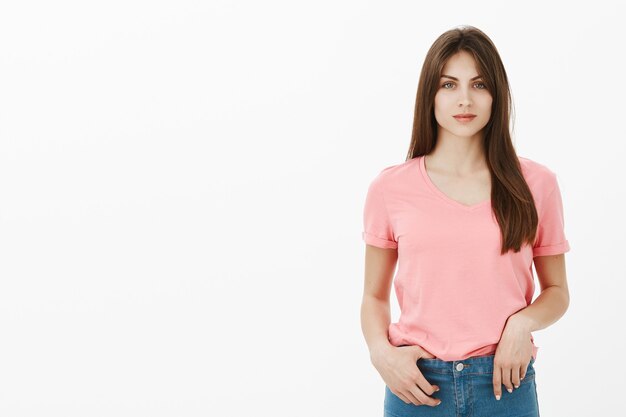 Portrait de femme brune confiante qui pose en studio