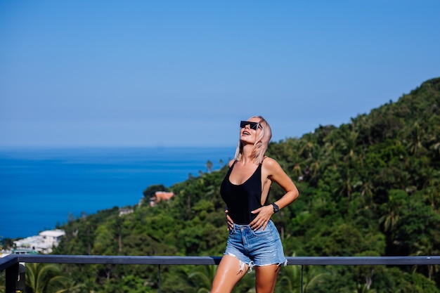 Portrait de femme européenne fit en maillot de bain et short en jean en vacances