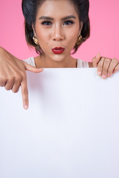 Portrait de femme de mode affichant une bannière blanche