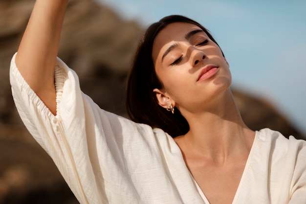 Photo gratuite portrait de femme à la plage avec une ombre couvrant son visage