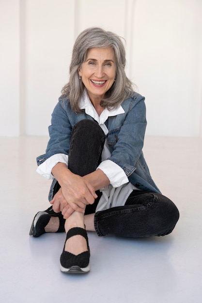 Portrait de femme plus âgée posant dans une veste en jean