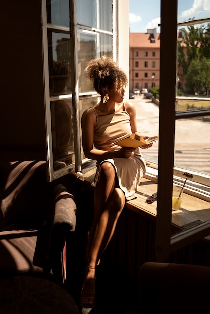 Portrait de femme riche à l'intérieur avec un livre