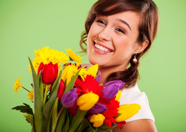 Portrait d'une femme souriante avec des fleurs colorées