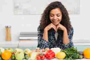 Photo gratuite portrait de femme souriante à la recherche de légumes