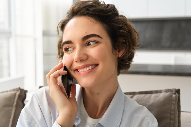 Portrait en gros plan d'une belle femme souriante parlant sur des chats de téléphone portable sur des appels de smartphone someo