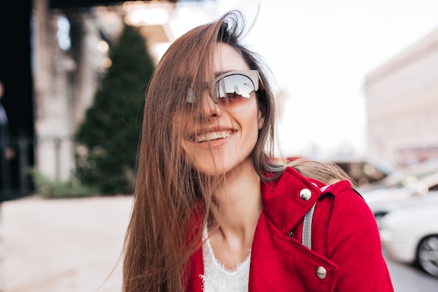 Photo gratuite portrait en gros plan d'une dame européenne agréable dans de grandes lunettes de soleil