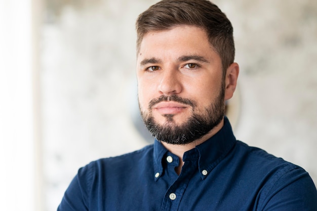 Photo gratuite portrait d'homme barbu tenant ses bras croisés