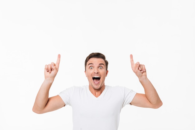 Portrait d'un homme excité amusé dans un t-shirt blanc