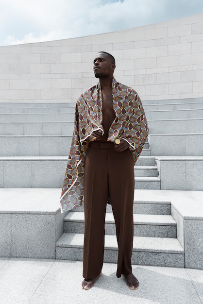 Photo gratuite portrait d'un homme posant en tenue africaine traditionnelle à l'extérieur