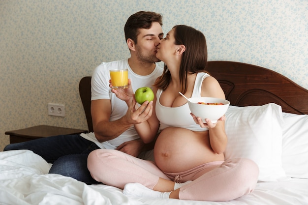 Portrait d'un jeune couple enceinte heureux