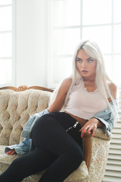 Portrait de jeune femme blonde avec une peau bronzée et des vêtements de mode