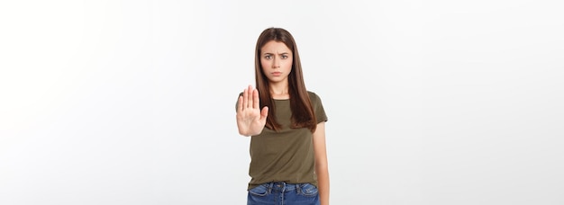 Portrait de jeune femme faisant signe d'arrêt devant la caméra