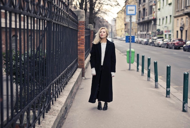 portrait de jeune femme en manteau noir dans la rue