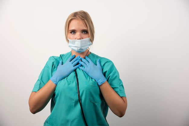 Portrait de jeune femme médecin portant un masque de protection.