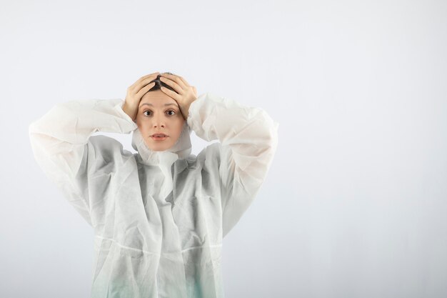 Portrait de jeune femme médecin scientifique en blouse de laboratoire défensive posant.