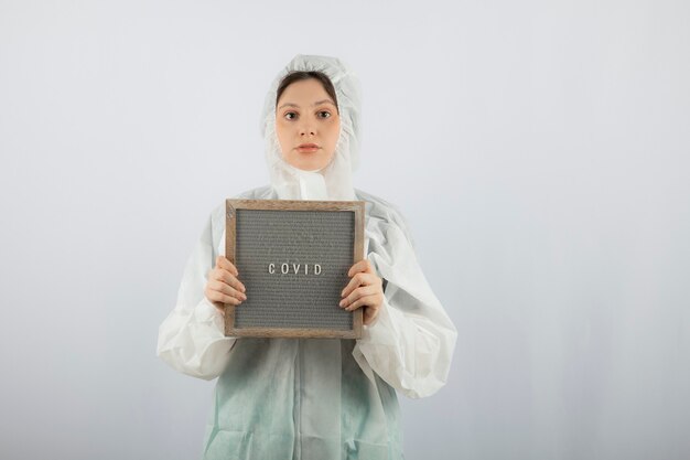 Portrait de jeune femme médecin scientifique portant une blouse de laboratoire défensive.