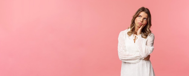 Portrait d'une jeune fille blonde sérieuse et mal à l'aise