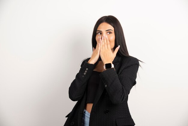 Portrait de jeune fille brune posant sur fond blanc. Photo de haute qualité