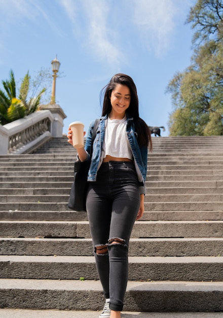 Portrait d'une jeune fille souriante tenant une tasse