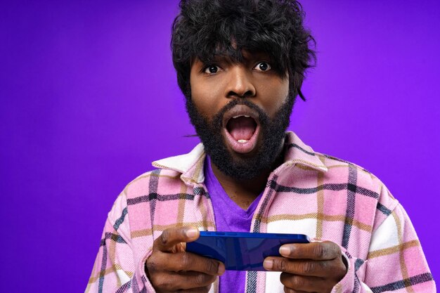 Portrait d'un jeune homme heureux et heureux avec un téléphone portable