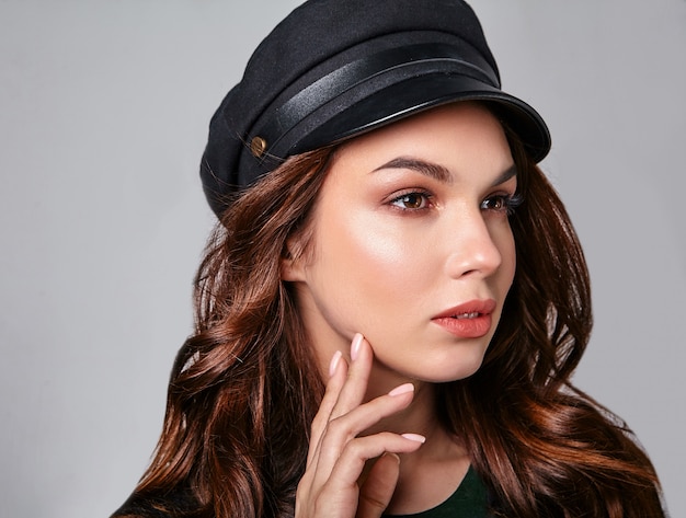 Portrait de jeune modèle riant élégant en vêtements d'été décontractés noirs en casquette avec maquillage naturel sur gris