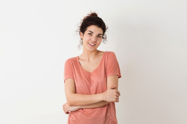 Portrait de jeune naturel à la recherche de sourire heureux hipster jolie femme en chemise rose posant isolé sur fond blanc studio